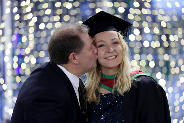 Abigail Bester from Belfast graduates from Ulster University with MSc in Marketing at the Winter Graduation Ceremony. Abigail gets a kiss from her dad Rob Bester.