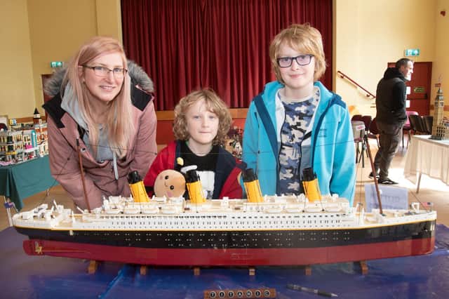 The most popular exhibit at the Lego exhibition was the Lego Titanic. Pictured viewing the piece are Carolyn Flanagan and children, Matthew (8) and James (11). PT15-205.