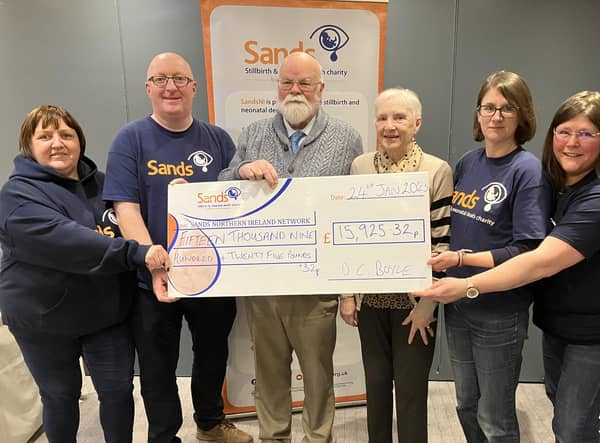Caring Caretaker Davy Boyle and his wife Teresa (centre) present £15,925.32 to representatives of SANDS NI (from left) Jacqui Guy, Steven Guy, Claire Charles and Sara McCloskey