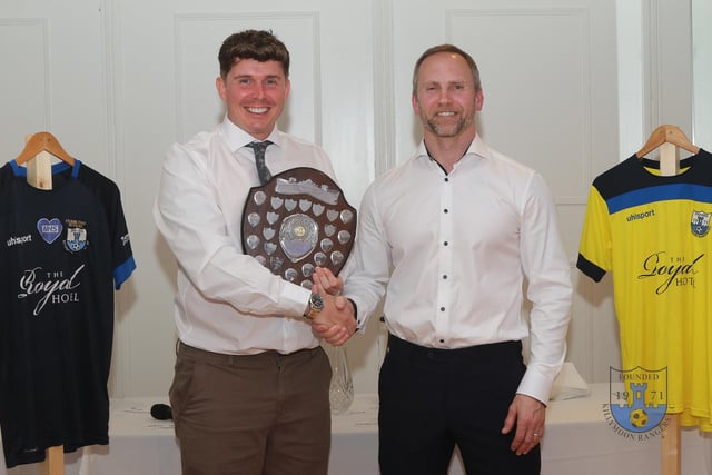 Picking up an award at the end of season celebration.