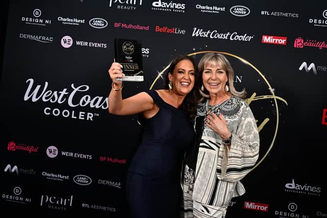 Dr Carla Devlin from Berkeley Aesthetics is presented with the trophy for Mobile  Home-Based Specialist Business of the Year from Kerry Patterson of DermaFrac UK, event partner of NI Beauty Excell