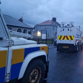 PSNI Land Rovers lined up and waiting in a side street off the Garvaghy Road in Portadown as protesters filled the road. They were protesting at the Parades Commission determination to permit Portadown Orange District to march through the Garvaghy Road.