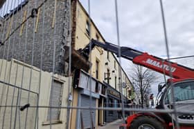 Unsafe building in William Street, Lurgan, Co Armagh with a digger at its facade.