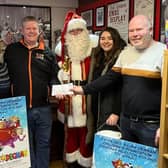 Gerald Degnan, from the Eilish Degnan Children's Foundation, receives a cheque from the Rinkha team and Santa. Photo submitted by G Degnan