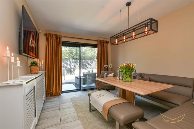 Dining room with tiled flooring and sliding patio door to rear garden.