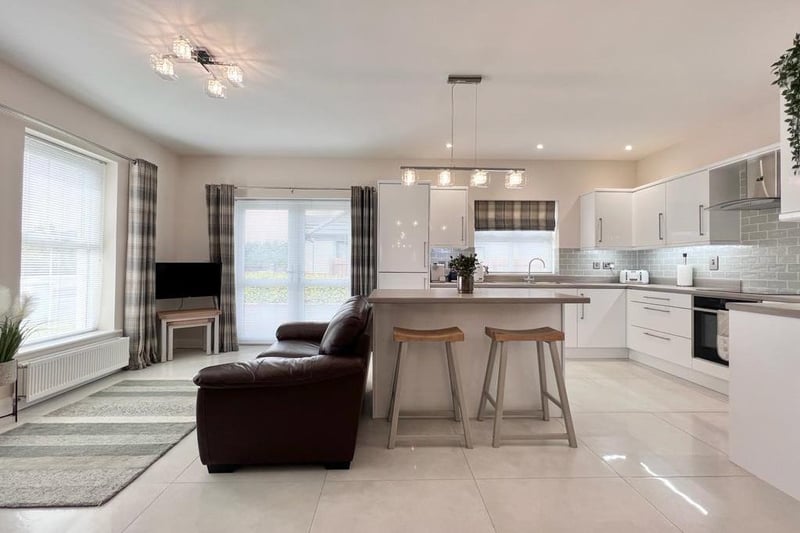 The open plan kitchen / dining / living area has been decorated in modern neutral shades.