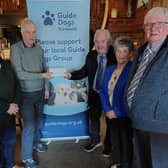 Finlay McBride and friends present a cheque for £1322.00 to Robert McKinnon representing Guide Dogs N