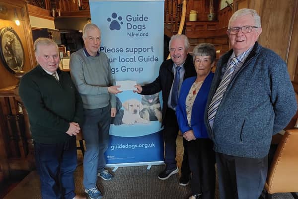 Finlay McBride and friends present a cheque for £1322.00 to Robert McKinnon representing Guide Dogs N