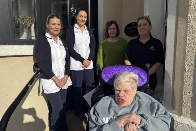 L-R: Samantha Boyle, Learning Disability Occupational Therapist; Caoimhe Kirkpatrick, Learning Disability Occupational Therapist; Sonia Bradley, Duncreggan Residential Home Manager; Sarah Toner, Duncreggan, standing with Elizabeth in her new bespoke moulded wheelchair.