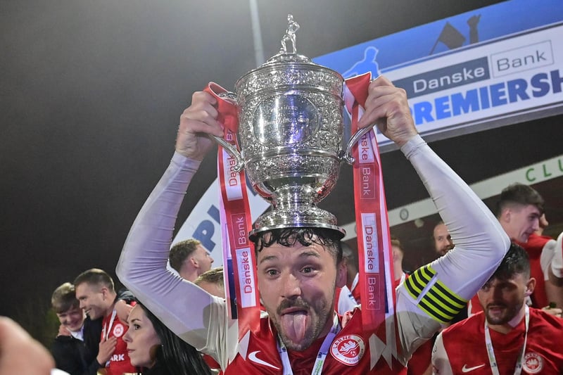 Larne skipper Tomas Cosgrove lifts the Gibson Cup for the first time in Larne’s 134-year history at Inver Park on Friday night.