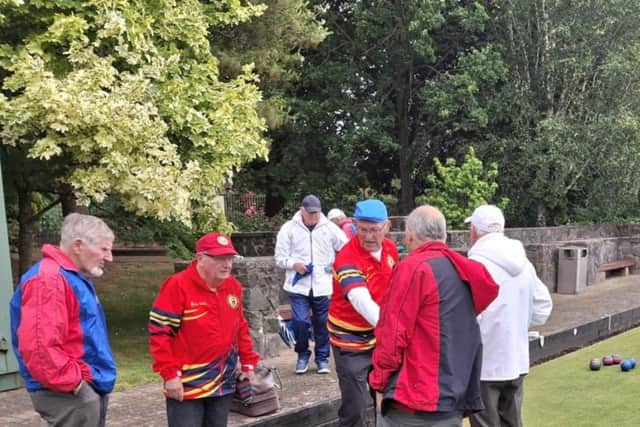 Stewart Martin and Billy Martin, respective of Lurgan Red and Portadown shaking hands at the conclusion of their Veteran's match won by Portadown and played extremely challenging weather conditions
