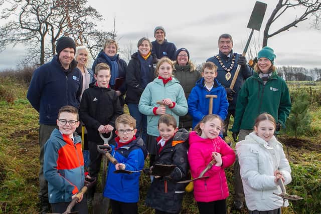Ald Williams with Andrew Gallagher RSPB, Gareth Bareham RSPB, staff and pupils from Woodburn PS, Marlene Gattineau and Vanessa Postle MEA Council Parks and Open Spaces.