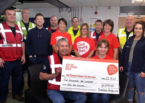 Staff from Interface, Lurgan present a cheque for Â£2555.00 to NI Chest, Heart and Stroke. The money was raised through a sponsored walk around Craigavon Lakes in memory of late colleague, Michael McGilly. The cheque was presented by shift manager, Chris McKeag to Sinead Lynch of the NICHS.