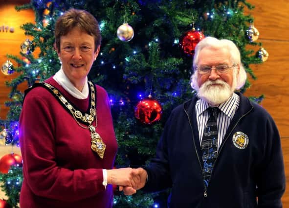 The Mayor of Causeway Coast and Glens Borough Council, Councillor Joan Baird OBE, congratulates Peter Langton on his 40 years of dedication to the Girona Community Orchestra.