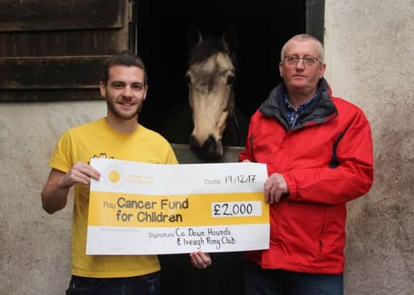 Robbie Mulligan presented the cheque to Andrew Boal NICFFC looking on is pony - Spider
