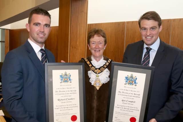Richard Chambers and Alan Campbell Freemen of the Causeway Coast and Glens Borough Council look over their certificates with the Mayor Cllr Joan Baird. PICTURE KEVIN MCAULEY/MCAULEY MULTIMEDIA/CCGBC