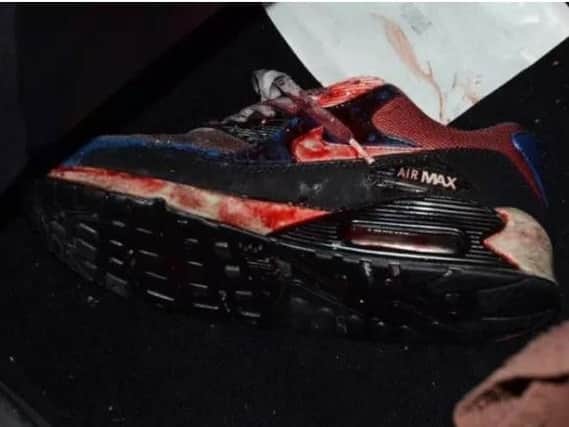 The bloodied trainer belonging to the shooting victim.