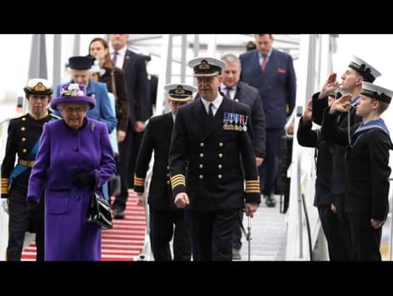 Philip Crozier (far right, middle) pipes Her Majesty The Queen aboard her namesake vessel during the ceremony.