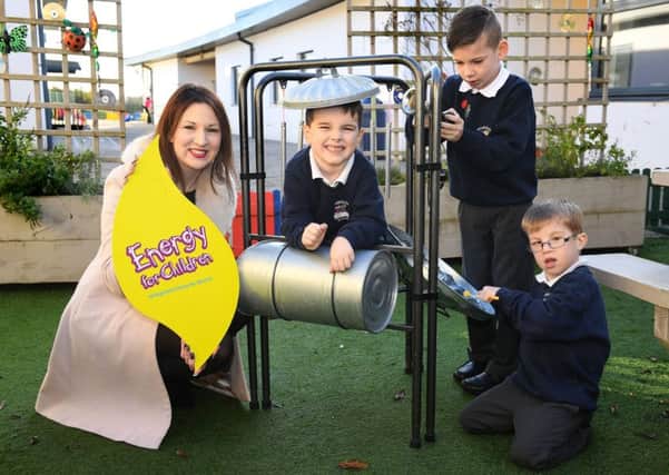 Energy for Children Charity Liaison Officer, Geri Wright, congratulates pupils from Brookfield School on receiving funding for equipment for an outdoor sensory classroom to aid learning and improve social interaction.