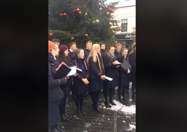 Wallace High School choir sing festive songs in Lisburn's Market Square.