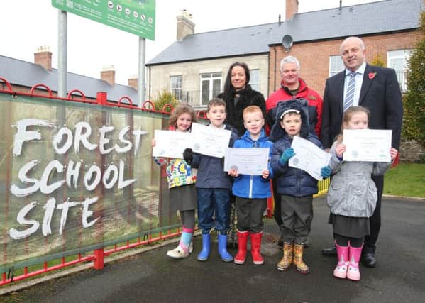 Children from Downshire Primary School receiving their NIFSA Nature Ranger Award Certificates. They are pictured with their teacher Marie Cummings, Brian Poots from Forest Schools and Chairman of Lisburn & Castlereagh City Council's Leisure & Community Development Committee, Alderman James Tinsley.