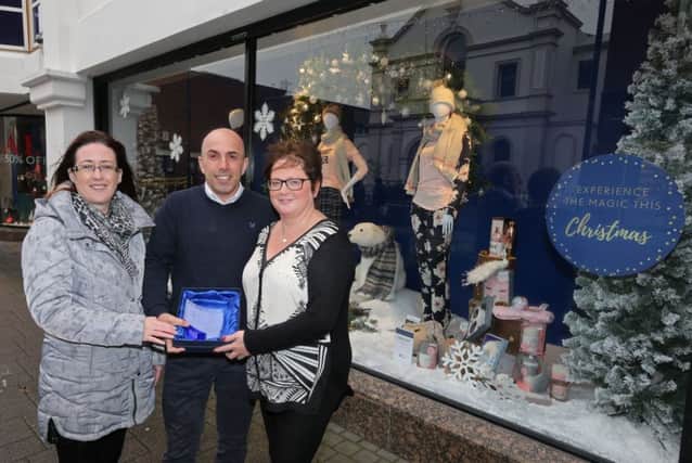 Simon Colquhoun and Jayne Booth from Moores receive their prize after the shop was selected as the winner of the Christmas Window Competition in Coleraine. Also included is Causeway Coast and Glens Borough Council Officer Catrina McNeill.