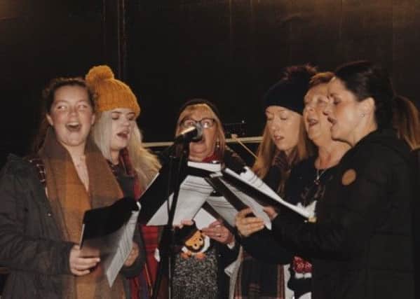 the community choir sing festive songs