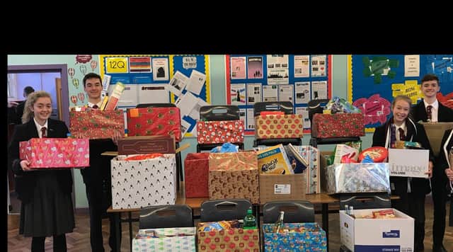 Pupils at Carrickfergus Grammar with some of the food hampers.