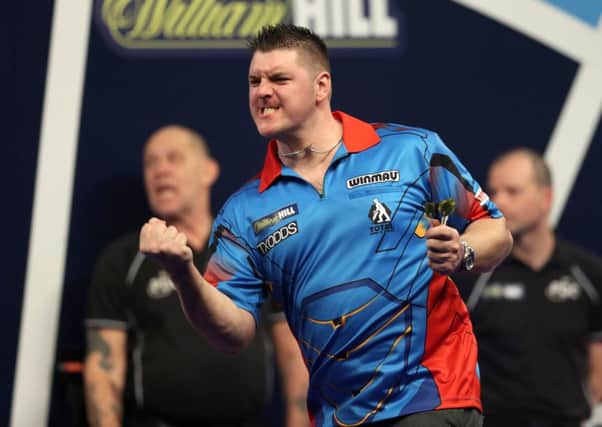 Daryl Gurney celebrates his first round win during day five of the William Hill World Darts Championship at Alexandra Palace