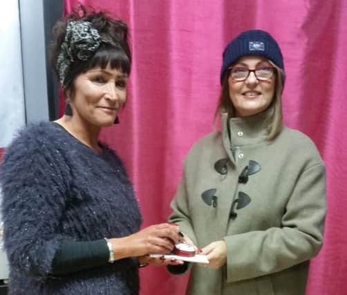 Pauline Templeton receives her diamond ring from Action Cancer's Angie Lamont.
