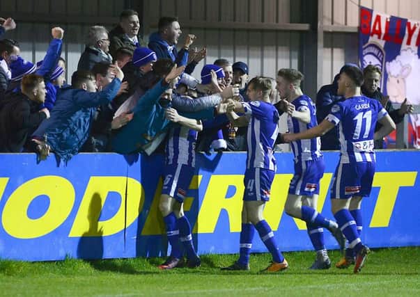 Coleraines Ian Parkhill celebrates with team mates and supporters after opening the scoring in the 2-0 win over Warrenpoint Town