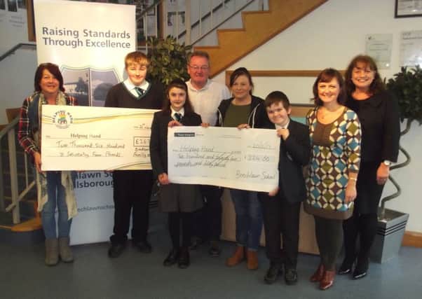 Bradlee Russell was joined by family members and Beechlawn School staff and pupils as he handed over Â£2,674 to the Helping Hand charity.