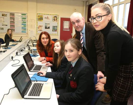 National Trust Regional Director Heather McLachlan, Mr Smyth and Miss McAuley from Dunluce School are pictured with some of the pupils who have benfited from the funding