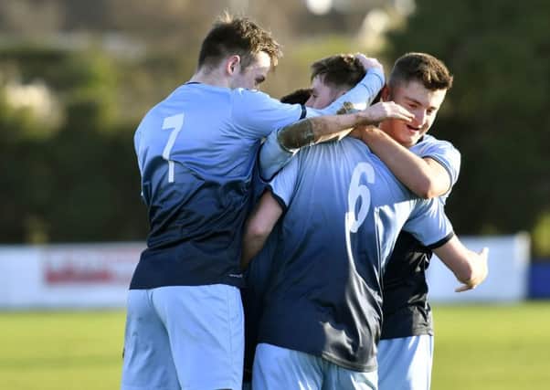 Institute's Niall Grace (NO 6) is mobbed by his team mates after he had scored the second goal of Saturday's match against Limavady United. DER0118-104KM