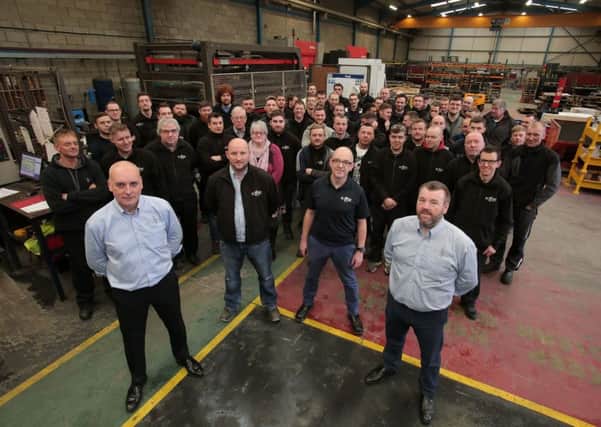 KME Steelworks directors Seamus Murchan (Front left) and Jason Quinn (front right) mark the end of a high growth year with staff at the Lisburn plant.