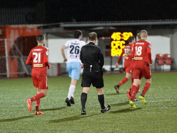 Officials and players leave the ground after the match at Solitude was abandoned due to adverse weather conditions