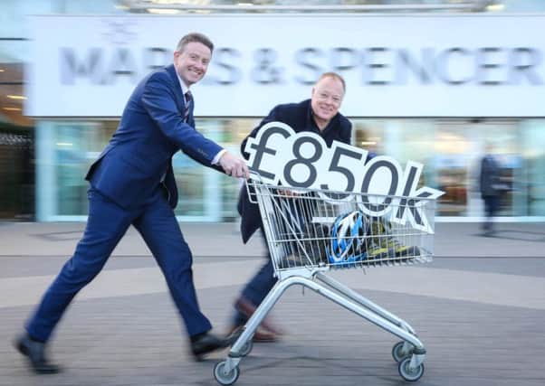 (l-r) Ryan Lemon, M&S Head of Region for Northern Ireland and Dougie King, Head of Fundraising & Communication at Action Cancer make a mad dash to celebrate M&S employees across Northern Ireland raising more than Â£850,000 for the regions charity fundraising campaign in aid of Action Cancers counselling and therapeutic