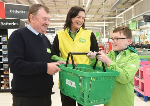 Asda Antrim General Store Manager Robert Ryans with Asda Colleague Kirstie Ainsworth and Jude.