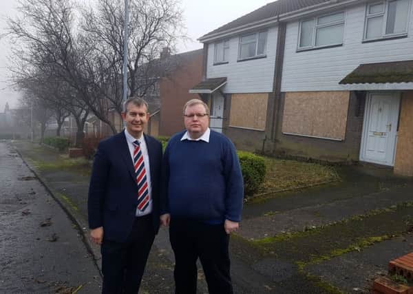 Edwin Poots MLA and Cllr Jonathan Craig outside the former MoD houses on Mountview Drive.