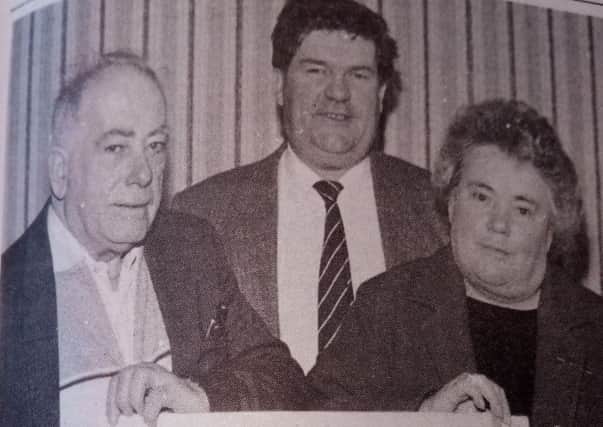 Pub With No Beer winner Sean McIlwee receives his prize from Mrs Goodall as Michale Madden looks on. 1989.