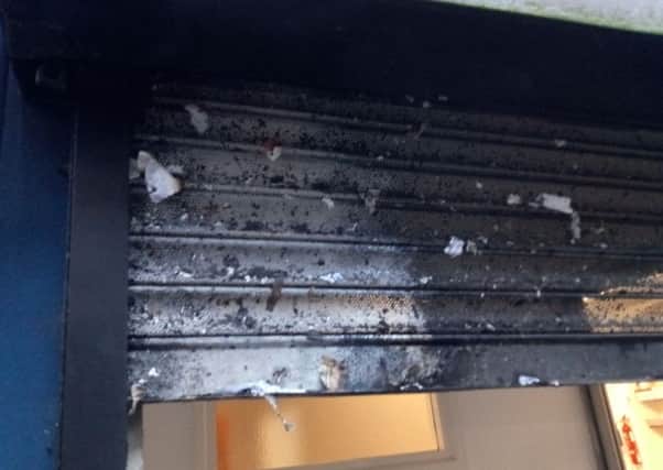 A scorch-damaged shutter at the Dunluce Street premises.