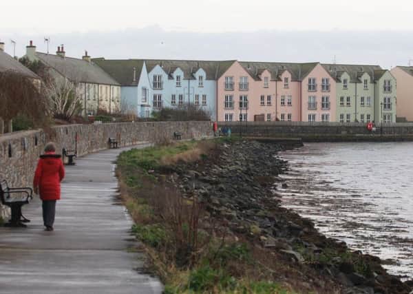 A hardy walker makes the best of the weather in Killyleagh before a forecasted cold snap moves in on Monday