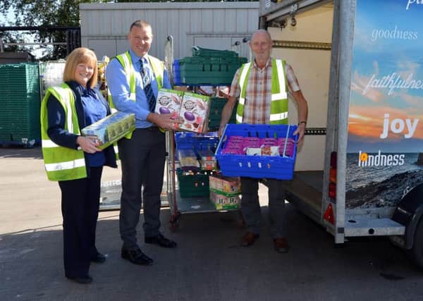 Tesco Portadown have donated over Â£3000 worh of food to Craigavon Area Foodbank. Pictured at the handoverof some of the goods are from left, Anita Hamilton, stock control, Jonny Craig, trade manager and Stanley Harkness, food bank volunteer.INPT38-212.