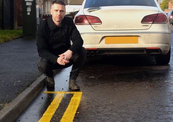 Sinn Fein Councillor, Keith Haughian pictured at the recently painted double yellow lines on Shankill Street. INLM05-213.