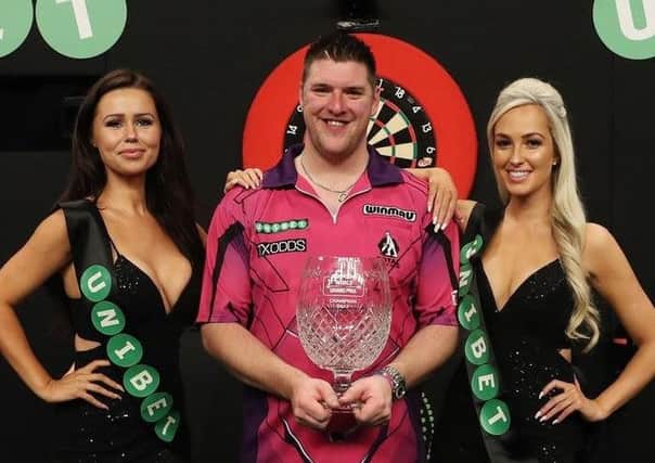 Daryl Gurney pictured with two walk-on girls after his World Grand Prix win in Dublin last year