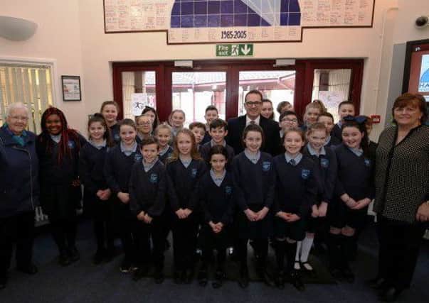 Baroness May Blood (l) of the Integrated Education Fund, Shadow Secretary of State Owen Smith MP (Centre) and principal Patricia Murtagh (r) with members of the Hazelwood Integrated Primary School choir who greeted the VIP visitors last Friday.
Pic Credit Â©Pressye.com / Matt Mackey