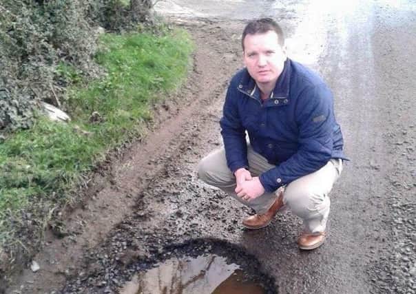 Councillor Glenn Barr has called on motorists to report potholes.