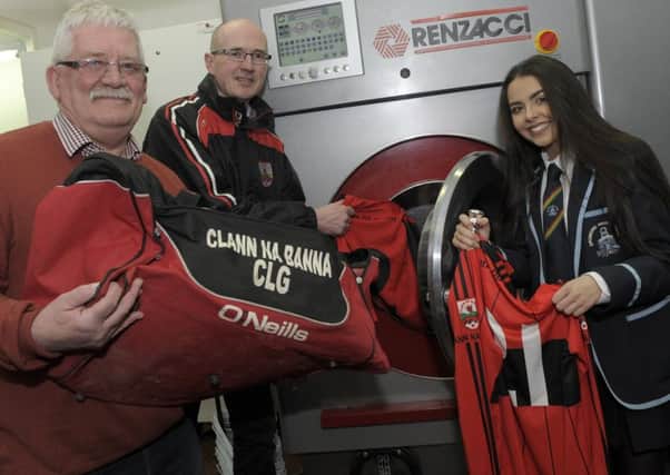 Clann na Banna CLG have donated jerseys and shorts to the 'Kenya 2018 Team' at Dromore High School to bring out to Kenya when they go in March. White Label Cleaners on the Castlewellan Road have offered to launder all the items free of charge. Loading up the washing machine are, from left, Roy Hodgen (White Label Cleaners), Pat Vaughan (Clann Ma Banna) and Sara Topley (Kenya 2018 Team). Pic by Edward Byrne Photography INBL1806-201EB