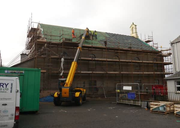 Work gets under way to replace the roof of Molesworth Presbyterian Church.