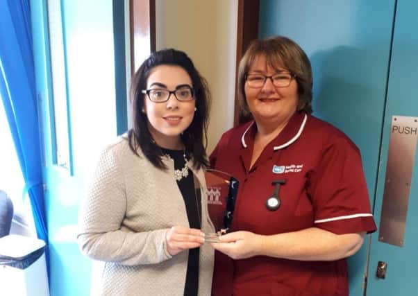Patient Grace Lynam presents Bernie Trainor Stoma/Coloproctology Nurse for the Southern Trust area with her Patients Choice Award from the charity Lets Talk Crohns and Colitis Association.